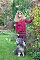 Garden owner Betina May with Bearded Collie Frido 