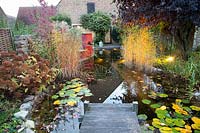 Illuminated garden pond in autumn 