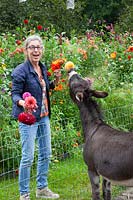 Anja van Heeswijk feeds donkeys with dahlias 
