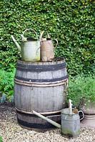 Old watering cans and water barrels 