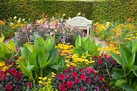 Seating area at the bed with annuals and dahlias 