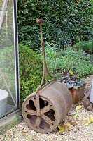 Antique lawn roller as garden decoration 