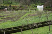 View down onto the geometric kitchen garden and the Exedra at Painswick Rococo Garden in Gloucestershire in March