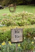 Wooden sign at Cerney House Gardens in Gloucestershire