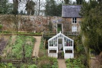 White greenhouse in the walled garden at Cerney House in March