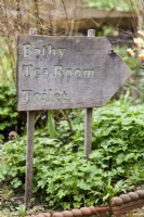 Wooden sign at Cerney House Gardens in March