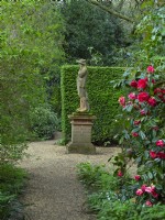  Statue in woodland area  East Ruston Old Vicarage Gardens, Norfolk,  Spring.