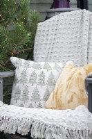 Cushions and blanket on recycled plastic chair