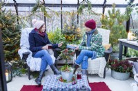 Women sharing food inside decorated greenhouse