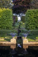Two large formal urns at the end of the rill that cascades into the formal pond