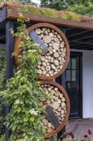 Urban front garden with Sedum green roof and round insect hotels made of wood and rusty rings surrounded by Hydrangea petiolaris. Designer: Nicola Haines, Citroen Power of One at Bord Bia Bloom Dublin 2023