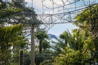 Classical style ornate metal temple with a view towards the St Mawes Harbour, hardy palms surround in this semi tropical garden