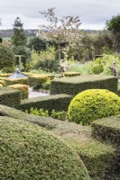 View across the Howdah Garden. Clipped hedges of Yew, round mound of Box. April, Spring. 